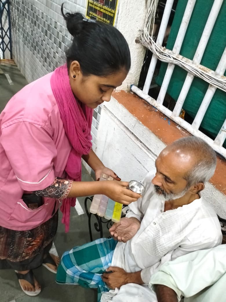 Nurse with weekly pill organiser